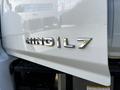 A silver emblem displaying the text HINO L7 on a white truck hood