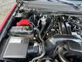 The image shows the engine bay of a 2011 Chevrolet Avalanche with visible components including the air intake system and battery