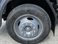 A close-up of a tire on a 2009 Ford LCF 550 showing the Firestone brand with a five-bolt pattern and a metallic silver wheel rim