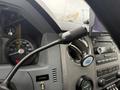The interior of a 2011 Ford F-650 featuring a speedometer a control knob and a digital display with various gauges and buttons