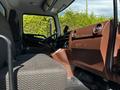 Interior view of a 2021 Hino 338 showing the driver's seat dashboard and console with a focus on the seating and controls
