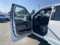 A 2017 Ford F-150 with its driver's side door open revealing the interior features and dashboard