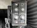 A control panel featuring six buttons labeled UP OPEN HOPPER DOOR DOWN and CLOSE with a chain attached to its side