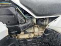Close-up of the engine compartment of a 2017 Polaris Scrambler showing various mechanical components and tubing