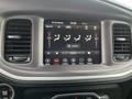The image shows the interior dashboard of a 2022 Dodge Charger featuring a touchscreen display with climate control settings and various controls