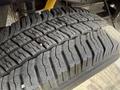 Close-up of a 2008 Ford F-250 SD tire showing detailed tread pattern and wear on the rubber surface