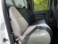 A 2009 Ford F-550 with a rear bench seat in gray upholstery and a simple interior design