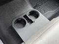 Close-up of a cup holder in a 2017 Ford F-350 SD with a textured surface and a black finish