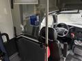 Interior view of a 2020 Chevrolet Express showcasing the driver's seat dashboard and partitioning barrier