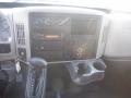 Dashboard of a 2014 International Durastar featuring gauges audio controls climate controls and a central console with cup holders and gear shift