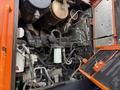 The image shows the engine compartment of a 2018 Doosan DL300-5 with various mechanical components including hoses and a fuel filter visible