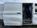 A white 2018 Mercedes-Benz Metris van with an open sliding door revealing a spacious interior and cargo area