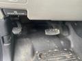 Foot pedals of a 2017 Ford F-550 including a brake pedal and a clutch pedal with noticeable wear and dirt on the floor mat