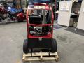 A 2024 Magnum 4000 Hot Water Pressure Washer with a red and black exterior featuring wheels a motor and control panel