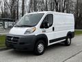 A 2018 RAM Promaster van with a white exterior and black accents parked on a street