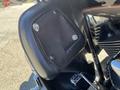 A black leather pouch with metal studs attached to the side of a 2004 Harley-Davidson Flhtcui motorcycle