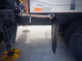 A 2016 International WorkStar 7500 truck featuring a visible side panel with a hose and a lowered access door next to large rear tires