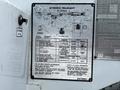 A metal information plate displaying specifications and instructions for a Terex Telelect XT Series equipment on a 2012 Freightliner M2 106