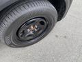 A close-up view of a black wheel and tire from a 2021 Ford Explorer showing five lug nuts and tread patterns on the tire