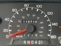 Close-up of a speedometer and odometer showing 112710 kilometers on a 2004 Ford F-750 dashboard