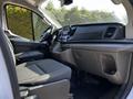 Interior view of a 2023 Ford Transit showing front seats dashboard and control panel