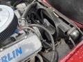 A 1970 Chevrolet Corvette engine with a chrome air filter aluminum intake and various hoses and components visible