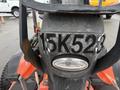 A close-up view of a 2015 Kubota F3990 tractor showing the front section with a prominent light and the number 15K523 on the body