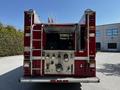 A red 2006 Emergency One Fire Truck with a visible rear panel featuring various controls and equipment for firefighting