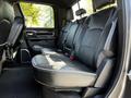 Interior view of the back seat of a 2022 RAM 3500 featuring black leather upholstery with seating for three and a spacious layout