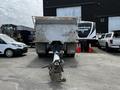 A 2013 K-Line 16 foot steel tandem pony 17 ton dump trailer with Air Weigh system attached to a hitch in the foreground