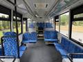 Interior of a 2018 Grande West Vicinity bus featuring blue patterned seats arranged in rows with an aisle in the center