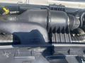 A close-up view of the engine compartment of a 2009 Ford Econoline showcasing the air intake system and various engine components