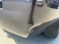 A 2016 Chevrolet Tahoe with noticeable scratches and dents on the rear bumper