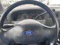 Steering wheel and dashboard of a 2003 Ford F-450 SD showing speedometer and various gauges