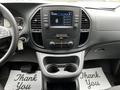 Interior view of a 2023 Mercedes-Benz Metris showcasing the dashboard with a touchscreen display and climate control buttons along with cup holders