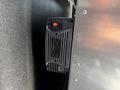 A Samlex Power inverter is mounted on a wall with an on/off switch and indicator lights visible on the front