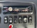 Dashboard controls of a 2012 Freightliner M2 112 featuring a Sony stereo system and a series of buttons for various functions including work lights and mirror heat