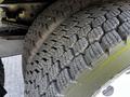 Close-up of a tire from a 2016 Isuzu NPR showing a detailed tread pattern and robust rubber texture