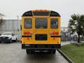 A yellow 2013 International 3000 school bus viewed from the rear showcasing its lights and bumper