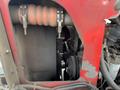 Close-up view of the engine compartment of a 2012 Toro Groundsmaster 5910 showing components like hoses and belts