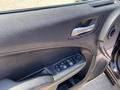 Interior door panel of a 2019 Dodge Charger showing control buttons for windows and door locks