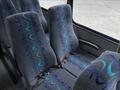 Interior seats of a 2020 Chevrolet Express featuring gray upholstery with blue and teal wave patterns and seatbelts attached