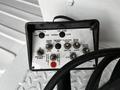Control panel with various buttons labeled for throttle, engine start, emergency power, boom operations, and directional controls
