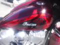 A red 2017 Indian Chieftain Elite motorcycle with intricate designs and the word Indian displayed prominently on the fuel tank