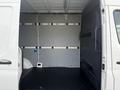 A 2022 Mercedes-Benz Sprinter van with an empty interior showcasing the cargo space and metal walls