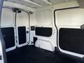 A 2017 Nissan NV200 interior view showing the empty cargo space with black flooring and walls lined with insulation panels