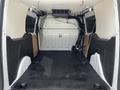Interior of a 2016 Ford Transit Connect cargo van featuring empty cargo space with side panels and a flat floor