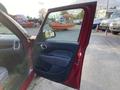 A 2015 Fiat 500L with an open door showcasing the interior and driver's side window