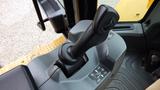 The control lever of a 2019 Caterpillar 972M XE with a textured, ergonomic grip and instructional diagram beside it