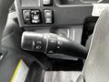 Close-up of the steering column stalk in a 2018 Isuzu NRR featuring controls for turning signals and cruise control